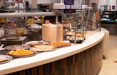 Counter with pizzas at a SU dining center.